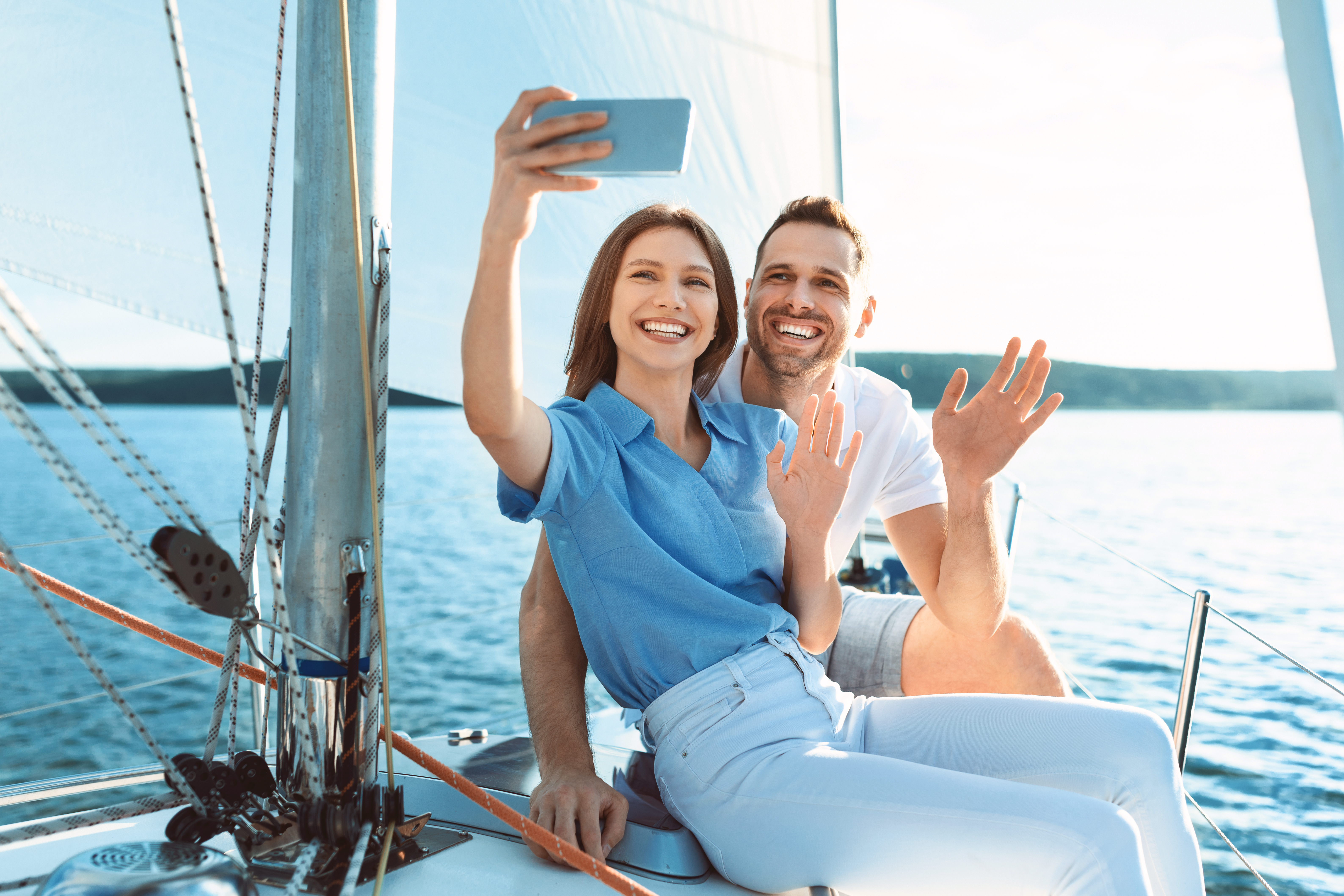 Joyful Spouses On Yacht Making Selfie And Waving Hand Outdoors